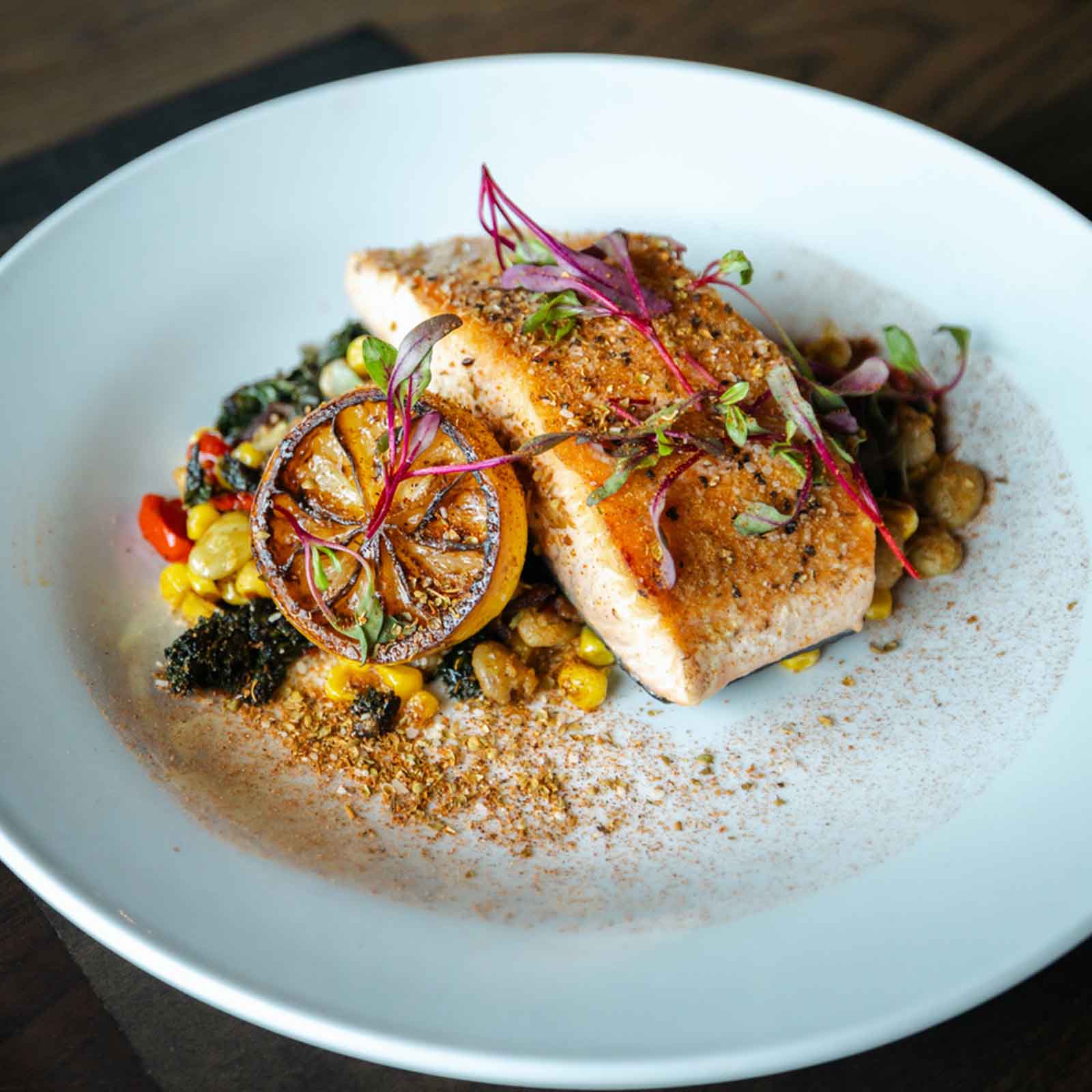 Grilled and season salmon with sauteed vegetables ready to serve