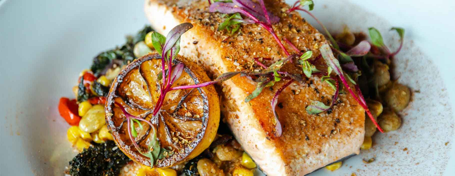 Grilled and season salmon with sauteed vegetables ready to serve