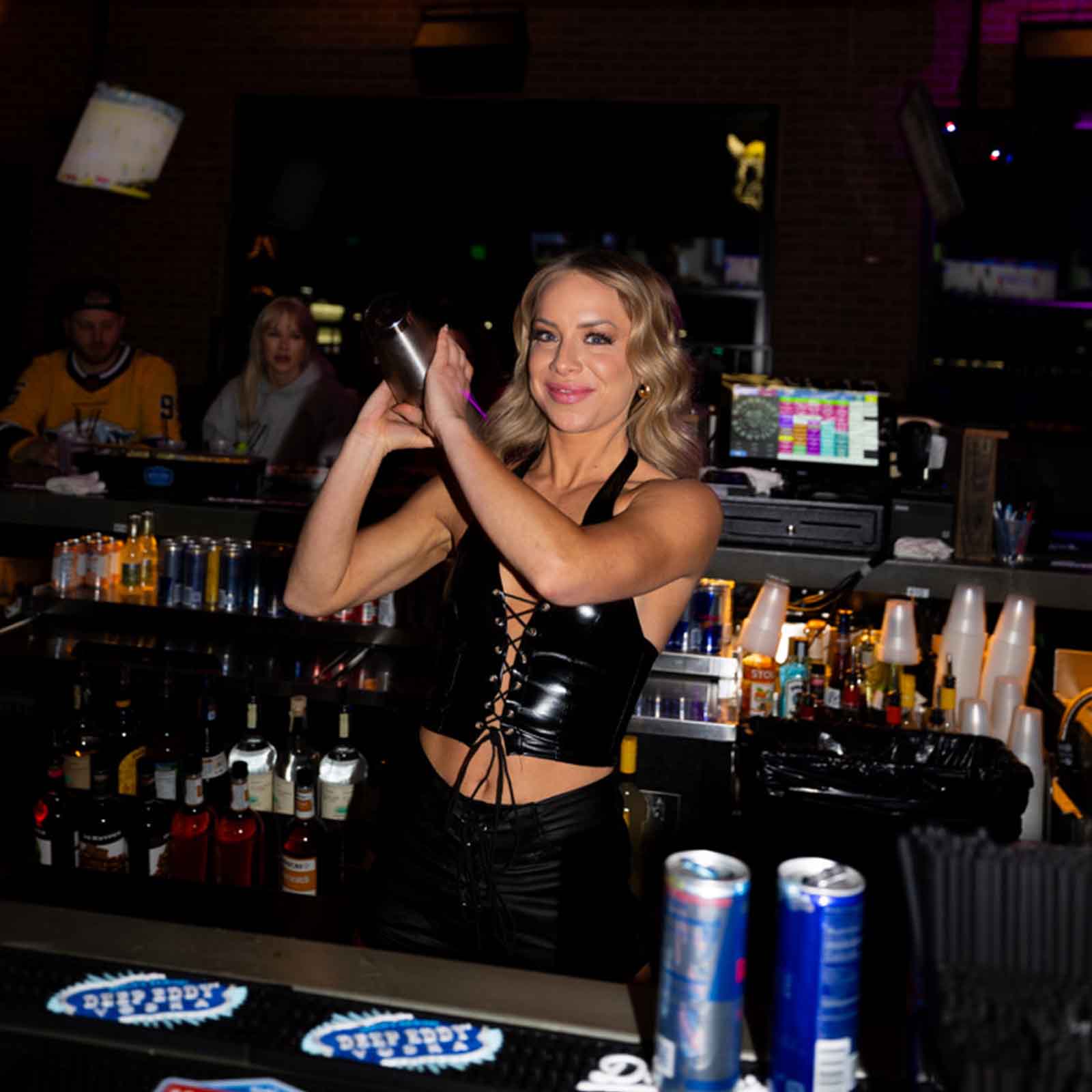 Bartender shaking a cocktail at the bar.